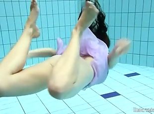 Purple dress falls off brunette in the pool