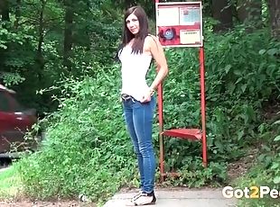 Chick in tight jeans takes a piss in public